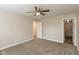A bedroom with neutral walls and carpeting, showcasing closet and entry door at 671 Greenway St, Greenwood, IN 46143