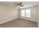 A neutral bedroom featuring a ceiling fan, two windows, and plush carpeting at 671 Greenway St, Greenwood, IN 46143