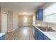 Modern kitchen with blue cabinets, stainless steel appliances, and new flooring with space for dining at 671 Greenway St, Greenwood, IN 46143