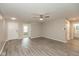 Spacious living room boasts gray flooring, recessed lighting, ceiling fan, and a view of the bathroom at 671 Greenway St, Greenwood, IN 46143