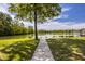 Landscaped backyard features a lovely lake view with direct access via private dock at 719 E New Rd, Greenfield, IN 46140