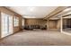 Large finished basement with plush carpeting, a seating area, and access to outdoors at 719 E New Rd, Greenfield, IN 46140