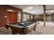 Open finished basement with a pool table, plush carpeting, and plenty of seating at 719 E New Rd, Greenfield, IN 46140