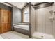 Bathroom featuring a tub under an arched window, a stand alone shower, and a tile floor at 719 E New Rd, Greenfield, IN 46140