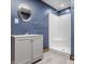 Bathroom featuring grey vanity with matching mirror, shower stall and wood-look floor at 719 E New Rd, Greenfield, IN 46140