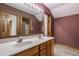 Double sink bathroom with a tile floor, a large mirror, and a nice overhead vanity light fixture at 719 E New Rd, Greenfield, IN 46140