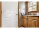 This bathroom features light wood cabinetry and a granite countertop with a framed window over sink at 719 E New Rd, Greenfield, IN 46140