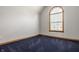 Comfortable bedroom featuring a large arch window, carpeted floors, and trim throughout at 719 E New Rd, Greenfield, IN 46140