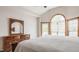 Comfortable bedroom showcasing a dresser with mirror and a patio door leading to the outside at 719 E New Rd, Greenfield, IN 46140