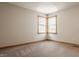 This bedroom features a large window with natural light and neutral carpeting at 719 E New Rd, Greenfield, IN 46140