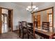 Dining room featuring a wood table, chairs, a chandelier, and access to other parts of the home at 719 E New Rd, Greenfield, IN 46140