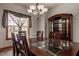 Traditional dining room featuring a wood table, chairs, a china cabinet, and natural light from the window at 719 E New Rd, Greenfield, IN 46140