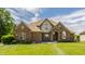 Charming brick two-story home with meticulous landscaping, a welcoming entrance, and a classic architectural style at 719 E New Rd, Greenfield, IN 46140