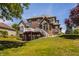 Exterior elevation of the home showing brick architecture, expansive windows, and a spacious backyard at 719 E New Rd, Greenfield, IN 46140