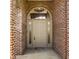 Covered front entryway features a classic door design with sidelights, set within a brick facade and decorative arch at 719 E New Rd, Greenfield, IN 46140