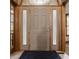 Traditional front door with sidelights, wooden trim and a welcome mat for an inviting entryway at 719 E New Rd, Greenfield, IN 46140