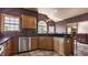 Bright kitchen featuring stainless steel appliances, granite countertops, wooden cabinets, and natural lighting at 719 E New Rd, Greenfield, IN 46140