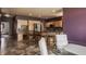 Open kitchen and dining area feature stainless steel appliances, granite countertops, wooden cabinets, and a breakfast bar at 719 E New Rd, Greenfield, IN 46140