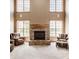 Spacious living room with a brick fireplace, large windows, and comfortable seating, offering a cozy atmosphere at 719 E New Rd, Greenfield, IN 46140