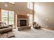 Bright living room featuring a brick fireplace, tall windows for natural light, and comfortable furniture arrangement at 719 E New Rd, Greenfield, IN 46140