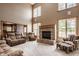 Open living space with soaring ceilings, a brick fireplace, large windows, and comfortable seating at 719 E New Rd, Greenfield, IN 46140