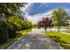Gravel path leading to the lake, surrounded by trees and grass, showcasing the property's access to waterfront at 719 E New Rd, Greenfield, IN 46140