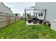 Spacious backyard with a patio, gazebo, grill, lawn, and wood fence at 7515 Brattle Dr, Indianapolis, IN 46113