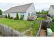 Spacious fenced backyard featuring a deck, patio, lush lawn, and well-maintained landscaping at 7515 Brattle Dr, Indianapolis, IN 46113