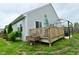Backyard featuring a wooden deck, patio, greenery, and fencing at 7515 Brattle Dr, Indianapolis, IN 46113