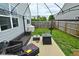 Backyard with a patio, cozy outdoor seating, fire pit, and well-manicured lawn enclosed by a fence at 7515 Brattle Dr, Indianapolis, IN 46113