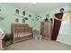 Whimsical bedroom with a charming wooden crib and Potter-themed decor at 7515 Brattle Dr, Indianapolis, IN 46113
