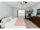 Bright bedroom featuring a ceiling fan, window, and a working desk at 7515 Brattle Dr, Indianapolis, IN 46113