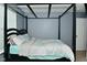 The bedroom boasts a unique canopy frame bed, and plenty of natural light at 7515 Brattle Dr, Indianapolis, IN 46113