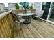Wooden deck with outdoor seating and sliding glass doors offers a relaxing retreat at 7515 Brattle Dr, Indianapolis, IN 46113