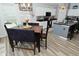 Dining area with a modern light fixture is naturally lit and ready for entertaining at 7515 Brattle Dr, Indianapolis, IN 46113