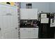 This modern kitchen features a door to the pantry, bright cabinets, and updated appliances at 7515 Brattle Dr, Indianapolis, IN 46113