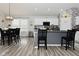 Bright kitchen features a dining area, an island with seating and sleek, modern appliances at 7515 Brattle Dr, Indianapolis, IN 46113