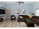 Charming living room with vaulted ceiling, ceiling fan, and decor creates a cozy ambiance at 7515 Brattle Dr, Indianapolis, IN 46113