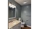 Bathroom features modern fixtures, grey walls, and wood-look floor at 7548 Briarstone Dr, Indianapolis, IN 46227