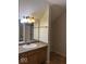 Bathroom with wooden vanity, updated mirror and lighting fixtures at 7548 Briarstone Dr, Indianapolis, IN 46227