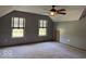 This spacious bonus room with carpeted floor, windows, and ceiling fan offers space to relax or play at 7548 Briarstone Dr, Indianapolis, IN 46227