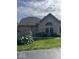 Charming brick home with lush landscaping and a well-manicured lawn at 7548 Briarstone Dr, Indianapolis, IN 46227