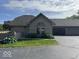 Charming brick home with lush landscaping and a two-car garage at 7548 Briarstone Dr, Indianapolis, IN 46227