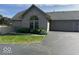 Charming brick home with lush landscaping and a two-car garage at 7548 Briarstone Dr, Indianapolis, IN 46227