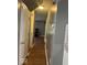 Hallway view showing doors and wood-look flooring at 7548 Briarstone Dr, Indianapolis, IN 46227