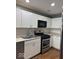 Kitchen with subway tile backsplash, white cabinets, and new appliances at 7548 Briarstone Dr, Indianapolis, IN 46227