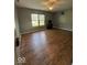 Bright living room with laminate flooring, large window, and ceiling fan at 7548 Briarstone Dr, Indianapolis, IN 46227