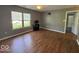 Bright living room with laminate flooring, large window, and ceiling fan at 7548 Briarstone Dr, Indianapolis, IN 46227
