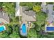 Aerial view showcases the house, the sparkling pool with lounge area, and mature trees surrounding the property at 790 Foxboro Dr, Avon, IN 46123