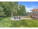 A circular stone patio with seating surrounds a fire pit near the yard, offering a cozy spot for gatherings and relaxation at 790 Foxboro Dr, Avon, IN 46123